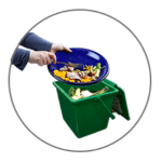 scraping food waste into a green compost container