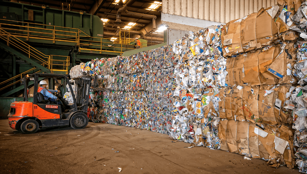 a forklift near a wall of baled recycled inventory at WM's sacramento recycling center