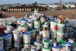 stacks of paint cans ready for household hazardous waste disposal