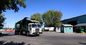 a green WM truck entering the gates at the Sage Street Transfer Station in Reno