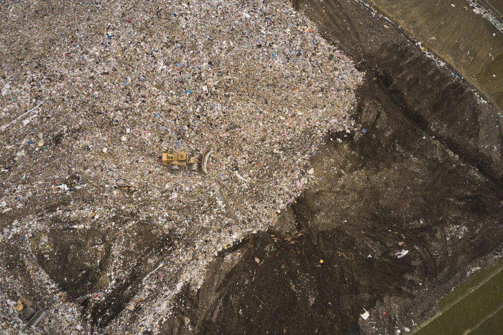 Front loader moving solid waste at a WM landfill.