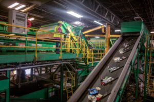 WM employee observed the conveyor belt from above, as the systems process recyclable materials.